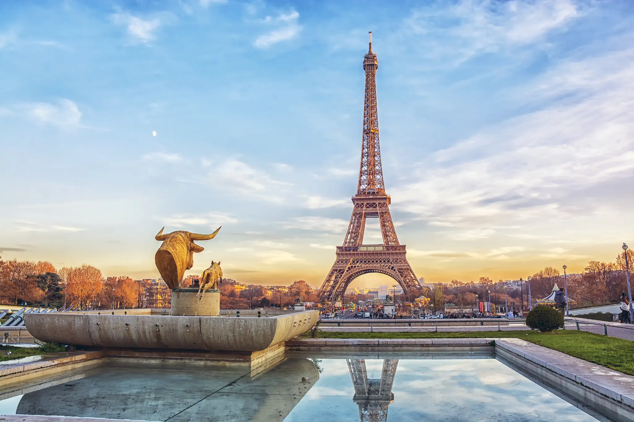 Eiffel Tower in Paris during sunset with reflecting pool and sculpture at Trocadéro